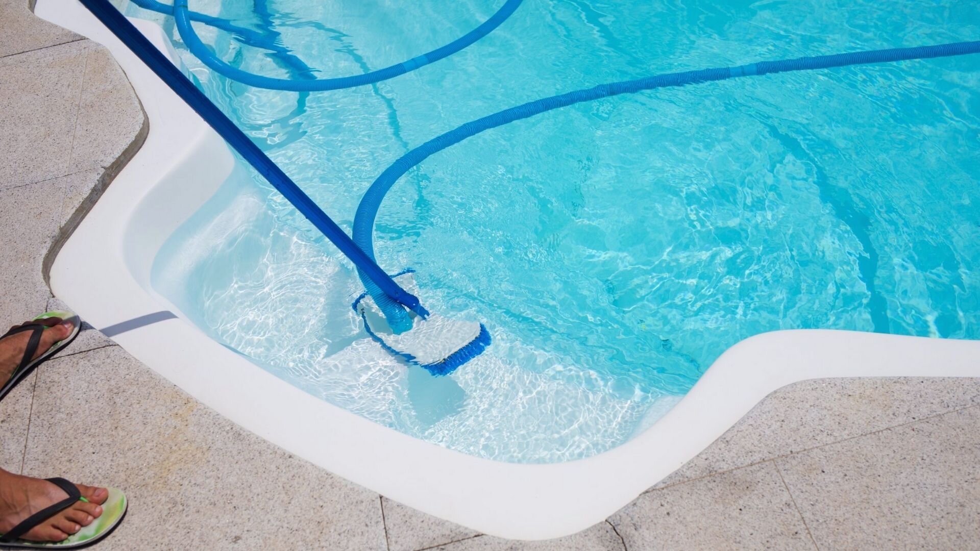 Man Maintaining Swimming Pool